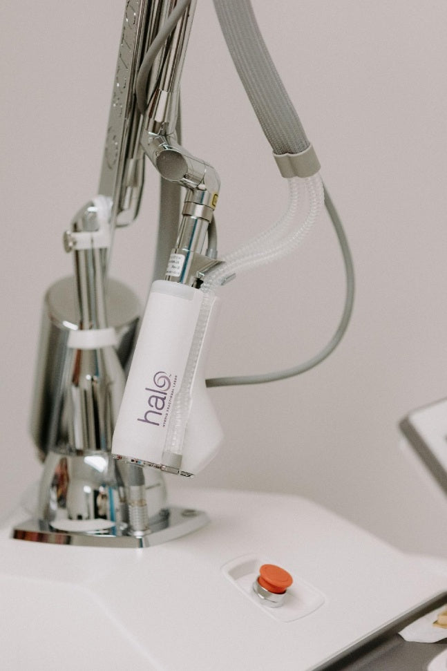 Patient receiving non-invasive facial skin treatment with laser device in medical clinic.